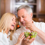 man and woman share a salad