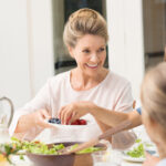 Grandmother eating with family