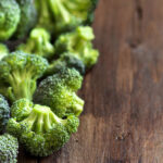 fresh broccoli on wooden table