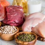 slices of poultry, beef, fish on wooden cutting board