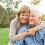 Senior couple hugging and smiling