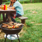 Barbecue grill and picnic table outside