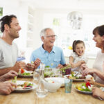 Smiling family eating together at the table