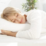 Smiling woman sleeping in bed