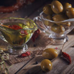 Olive oil and olives in glass bowls