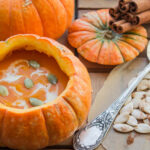 pumpkin soup served inside of a pumpkin