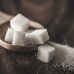 Sugar cubes in wooden spoon