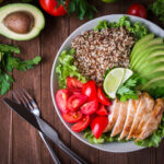 Salad bowl with quinoa, chicken, avocado, tomato