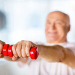 Older man lifting small weights