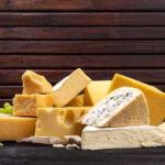 Selection of cheeses on wooden board