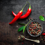 Whole red chili peppers and tricolor peppercorns