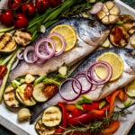 Whole fish baked with veggies and lemon