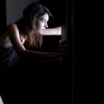 woman looking in fridge late at night craving