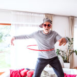 Senior man having fun with hula hoop