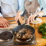 Couple cooking meal at home