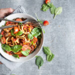 Bowl of zucchini noodles with tomatos