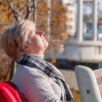 Woman outside, sun shining on her face