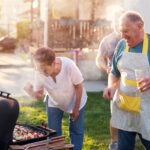 Family having fun grilling outside together