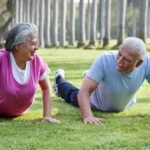 Active older couple exercising in the park