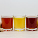 A selection of colorful kombuchas in clear glasses