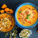 Bowl of pumpkin soup in blue bowl