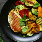 Plate of grilled chicken and roasted vegetables