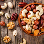 Mixed nuts in bowl on wooden table