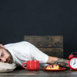 Man asleep at table after meal